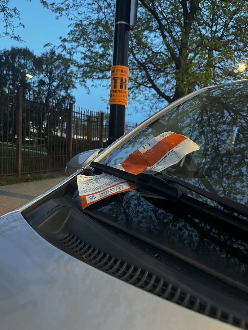 A Chicago parking ticket under a windshield wiper